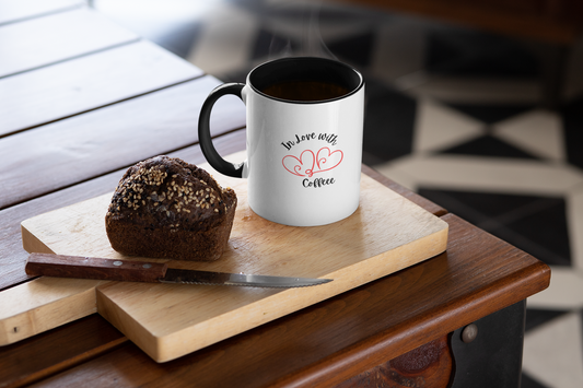 White mug with text and design on a wooden cutting board with a muffin and knife.